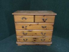 A pine four drawer chest and pair of bedside chests