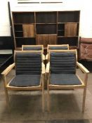 A set of four teak garden armchairs