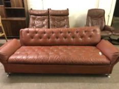 A late 20th century tan button leather three seater settee