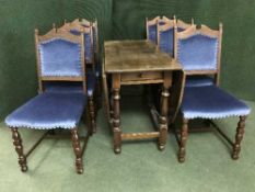 An oak drop leaf table fitted a drawer together with a set of six oak dining chairs