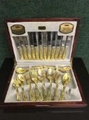 A mahogany canteen of Viners Gold Plated Collection cutlery set