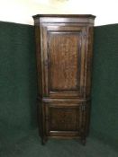 A Victorian oak corner cabinet