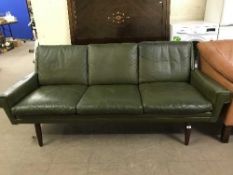 A late 20th century green leather three seater settee