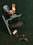 Two cast metal cockerel wall brackets with welcome sign