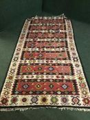 A fringed Persian Kilim rug of geometric design