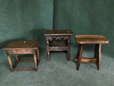 Two carved oak stools and one other