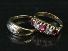 An 18ct gold ruby set ring together with a three stone diamond ring.