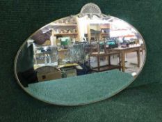An early twentieth century oval framed mirror