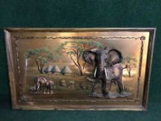 A teak framed copper relief picture depicting elephants
