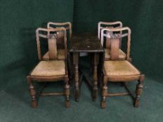 An oak gate leg table and four chairs