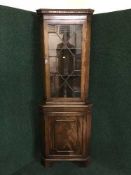 A mahogany glazed door corner cabinet