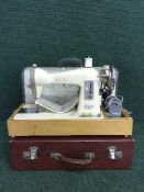 A Jones electric sewing machine and part cased picnic set