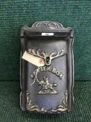 A cast metal wall mounted letter box