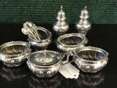 A seven piece silver cruet set by Walker & Hall, Sheffield 1901, with five matching spoons, 11.