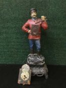 A novelty metal painted clock figure with key