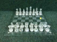 A glass chess board and pieces