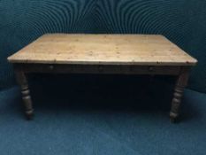 A large pine kitchen table fitted three drawers