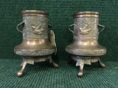 A pair of Oriental embossed copper vases depicting birds