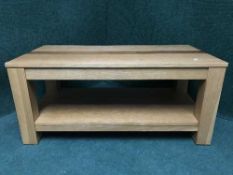 A contemporary oak two tier coffee table