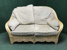 A three piece cane conservatory suite