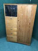 A teak compactum wardrobe