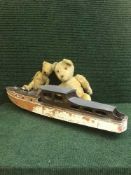 A model boat and two vintage teddy bears