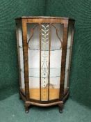 A mahogany bowfront display cabinet