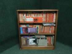 A teak sliding door bookcase and books