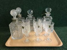 A tray of crystal and four decanters