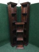 A pair of stained pine slim open shelves and similar smaller example