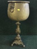 A large brass planter and stand