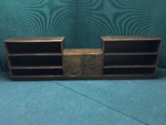 A set of low oak shelves fitted a cupboard