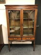 An Edwardian inlaid mahogany display cabinet