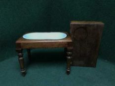 A mahogany footstool fitted a ceramic basin