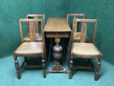 An oak drop leaf table and four chairs