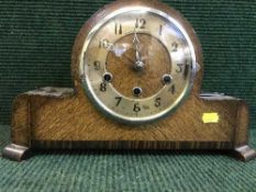 A Northern Goldsmiths oak mantel clock with key