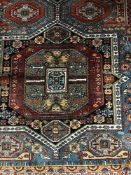 A fringed Persian rug of geometric design