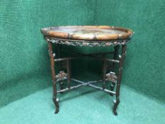 An oriental carved hardwood table