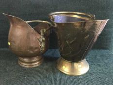 A copper coal bucket and brass coal receiver