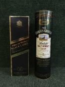 A bottle of Famous Grouse 1992 malt whiskey and a bottle of Jonnie Walker Black Label whiskey