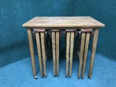 A nest of four teak tables