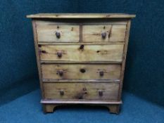 A pine five drawer chest