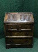 An oak bureau fitted three drawers