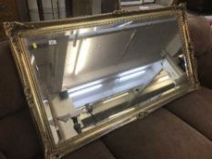 A large Victorian style gilt overmantel mirror