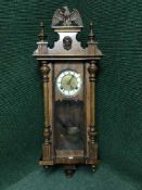 A mahogany cased Vienna wall clock with pendulum