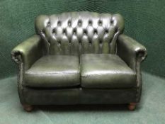 A green leather three piece suite