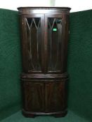 An inlaid mahogany corner display cabinet