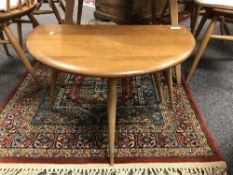 An Ercol light elm miniature flap-sided table