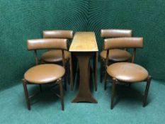 A teak drop leaf table and four vinyl upholstered chairs