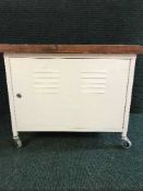 A metal storage trolley with pine top together with a floor lamp